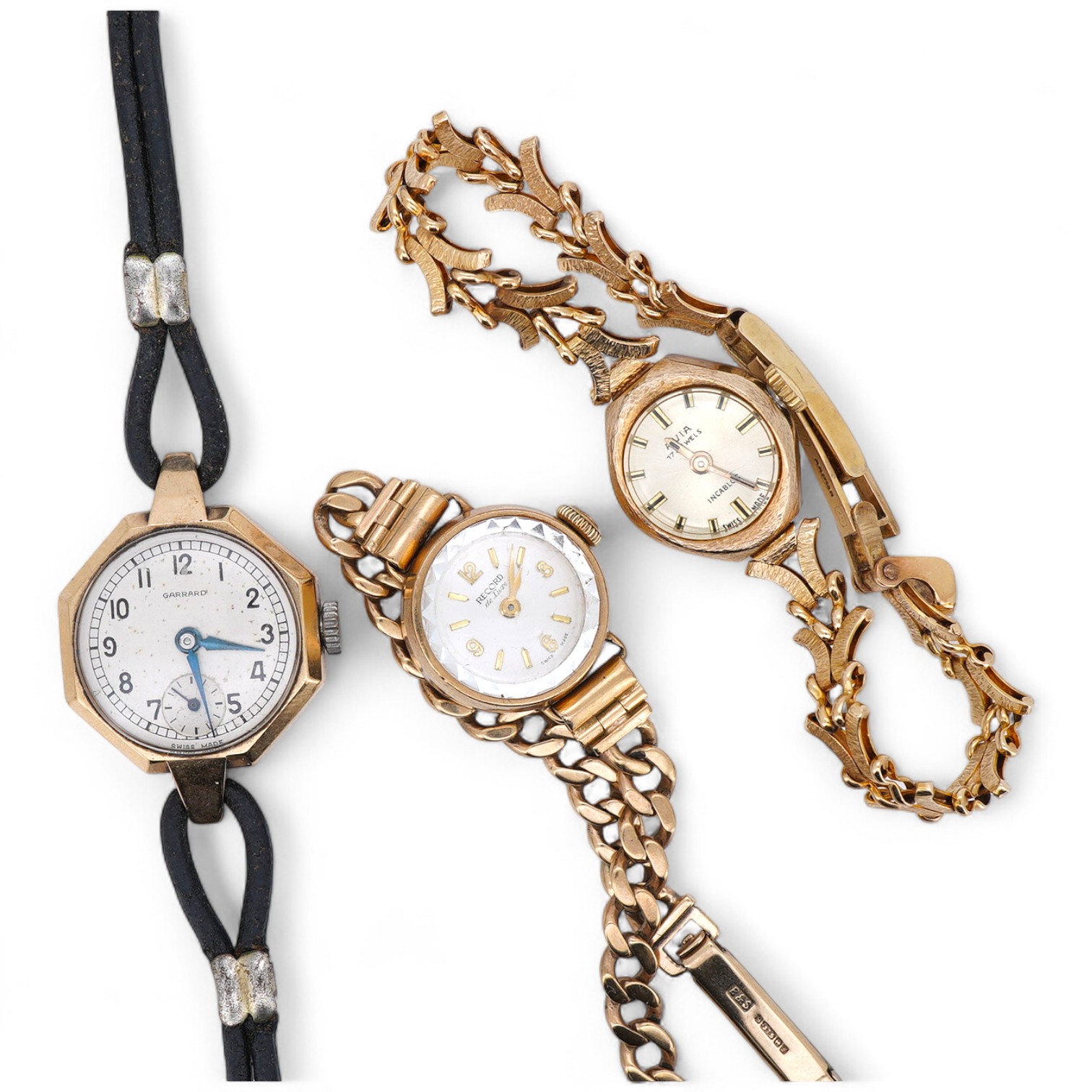 Three lady's 9ct gold wristwatches, mid 20th century, comprising: a gold wristwatch by Record, with a curb link strap; another wristwatch by Avia with a fancy link strap, combined gross weight approximately 23.5 grams; a